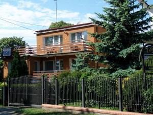 a house with a fence in front of it at Bursztynowa Wyspa in Gdańsk