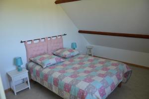 a bedroom with a bed and a table with a lamp at la ferme fleurie in Echinghen