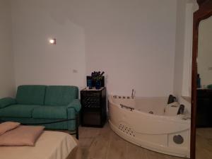 a living room with a bath tub and a couch at Dormi da me sul mare in Civitanova Marche +40 photos