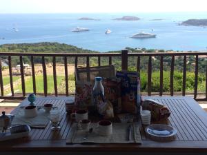 a table with a view of the ocean and boats at Paradiso in Costa Smeralda in Porto Cervo