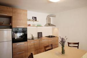 a kitchen with a table and a refrigerator at Apartments Roko in Tisno