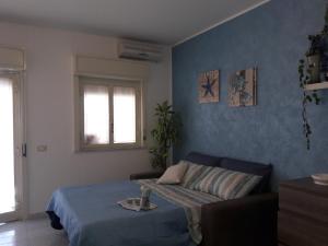 Ένα ή περισσότερα κρεβάτια σε δωμάτιο στο casa vacanza porta naxos giardini sicilia taormina