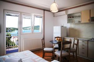 a kitchen with a table and a small table with chairs at Apartments Roko in Tisno