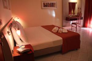 a bedroom with a bed with a phone and a desk at Meridian Hotel in Guardia Piemontese Terme