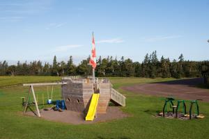 a playground in a park with a slide at Brackley Beach Northwinds in Brackley Beach