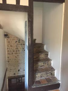 a mirror in a room with a stair case at Charmante Maison De Pêcheur in Honfleur +2 photos