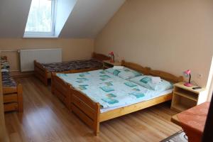 a bedroom with two beds and a window at Penzion Smrek in Habovka