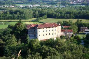 an old building on top of a hill with trees at B&B Castello di Camerletto in Caselette
