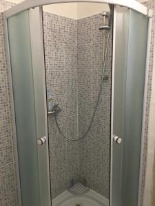 a shower with a glass door in a bathroom at Apartmán v Žltom dome in Banská Štiavnica +20 photos