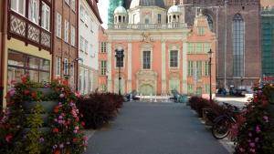 a large building with flowers in front of it at Apartament MARIA in Gdańsk