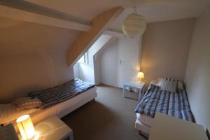 a room with two beds and a table and lamps at La Haute Flourie - bed and breakfast -chambres d'hôtes in Saint Malo