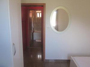 a bathroom with a mirror and a sink at Apartments Danilo Kažanegra in Sveti Stefan