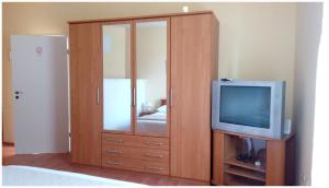 a large wooden cabinet with a television in a room at Apartmani Biočić in Split