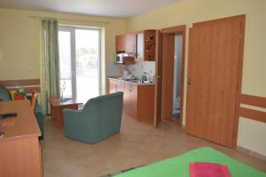a room with a kitchen and a living room at Apartmany Svaty Kriz in Liptovský Mikuláš