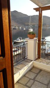 a balcony with a view of a body of water at Kamares Studios in Symi