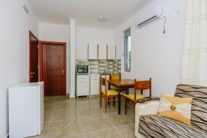 a living room with a table and a kitchen at Teuta Apartments in Ulcinj