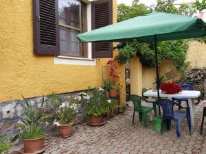 a patio with a table and chairs and an umbrella at B&B Sara in Ossi