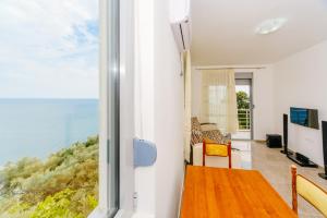 a living room with a view of the ocean at Teuta Apartments in Ulcinj