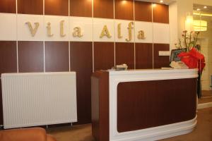 a dressing room with a table and a sign that reads vulum at Hotel Vila Alfa in Korçë