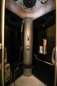 a small bathroom with a shower in a room at Rox Central Apartments 2 in Timişoara +23 photos