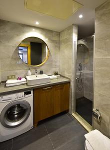 a bathroom with a washing machine and a sink at Degirmenburnu Residence in Bodrum City