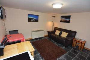 a living room with a couch and a table at Northness Apartments, Lerwick Self Contained in Lerwick