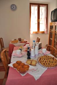 a table with two tables with food on it at Il Ciclamino Bed and Breakfast in Ascoli Piceno +17 photos
