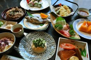 a table with many plates of food on it at Lake Oshino in Oshino