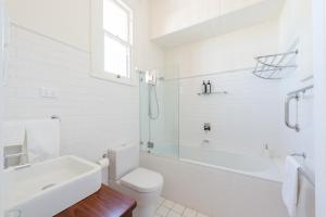 
a bathroom with a toilet, sink and bathtub at Post Office Apartment in York
