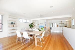 a kitchen and dining room with a table and chairs at 53 Hilton Esplanade, Tewantin in Noosaville