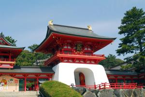a red and white building with a roof at KOKO STAY Shimonoseki - formerly Hotel Wing International Shimonoseki in Shimonoseki