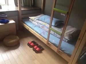 A bed or beds in a room at He&Her Youth Hostel