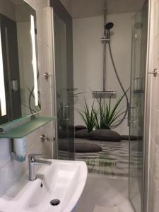 a bathroom with a sink and a mirror at Hotel Landsberg in Landsberg