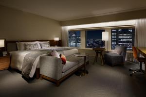 a bedroom with a bed and a chair and a window at Keio Plaza Hotel Tokyo Premier Grand in Tokyo