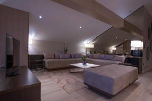 a living room with a couch and a table at Hotel Riva by Aycon in Petrovac na Moru