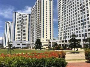 two tall white buildings in a park with flowers at Tagaytay Cool Spot in Tagaytay