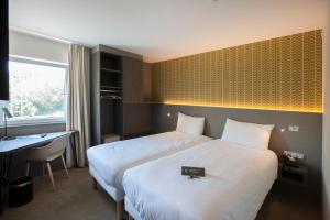 Postel nebo postele na pokoji v ubytování ibis Styles Kortrijk Expo
