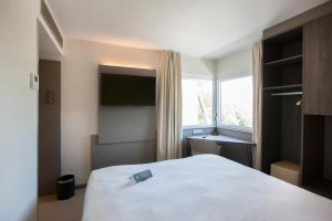 Postel nebo postele na pokoji v ubytování ibis Styles Kortrijk Expo