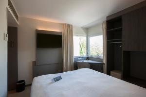 Postel nebo postele na pokoji v ubytování ibis Styles Kortrijk Expo