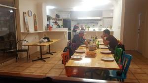 people sitting at a table in a kitchen at Dunsborough Beach Lodge in Dunsborough