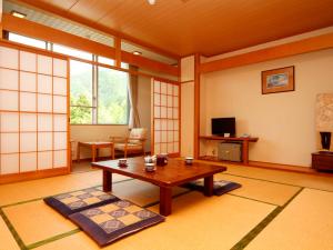 木曽町にある木曽文化公園 宿泊施設 駒王のテーブルとテレビのあるリビングルーム