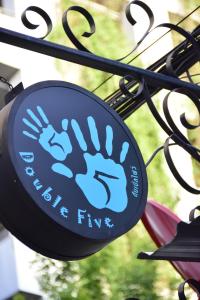 a blue sign with a hand on a iron fence at Double Five in Bangkok