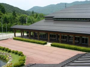 a building with a black roof and a patio at Komao in Kiso