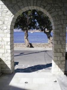 a stone archway with a view of the ocean at Hotel Paros in Parikia