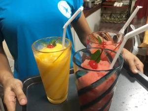 two cocktails sitting on a tray in a bar at Stardust Beach Hotel in Lian