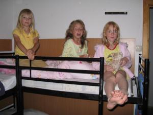 two girls sitting on top of a bunk bed at Hostel Schweriner See in Retgendorf