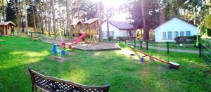 a park with a playground with children playing in the grass at Hostel Schweriner See in Retgendorf