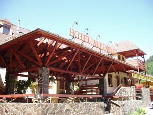 a wooden bridge over a building with a restaurant at Hotel Altenberg in Staré Hory