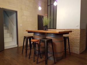 a bar made out of barrels with stools around it at Coeur de Saint Pierre in Bordeaux