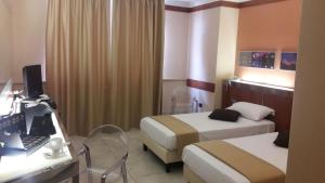 Posteľ alebo postele v izbe v ubytovaní Hotel Artemide